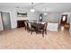 Dining room features a dark wood table with seating for six, and a view into another room at 6929 Farris Dr, Lakeland, FL 33811