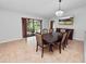 Bright dining room with dark wood table and chairs, offering pool view at 6929 Farris Dr, Lakeland, FL 33811