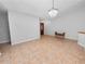 Dining room with tile floors and chandelier, open to living area at 6929 Farris Dr, Lakeland, FL 33811
