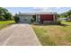 Ranch style home with a red accent wall and small yard at 6929 Farris Dr, Lakeland, FL 33811