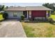 Ranch-style home with a gray exterior and mature landscaping at 6929 Farris Dr, Lakeland, FL 33811