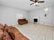 Living room with tile floors, fireplace and ceiling fan at 6929 Farris Dr, Lakeland, FL 33811