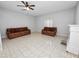 Living room with tile floors, fireplace and ceiling fan at 6929 Farris Dr, Lakeland, FL 33811