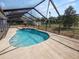 Relaxing kidney-shaped pool with a screened enclosure at 6929 Farris Dr, Lakeland, FL 33811