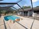 Large, kidney-shaped pool with screened enclosure and patio at 6929 Farris Dr, Lakeland, FL 33811