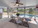 Relaxing screened pool area with patio furniture and built-in grill at 6929 Farris Dr, Lakeland, FL 33811