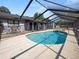 Inviting screened pool area with patio furniture and waterfall feature at 6929 Farris Dr, Lakeland, FL 33811