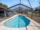 Inviting kidney-shaped pool with screened enclosure at 6929 Farris Dr, Lakeland, FL 33811