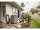 AC unit and private patio with sitting area at 726 Erie Ct, Lakeland, FL 33803