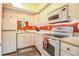Small kitchen with white appliances and red backsplash at 726 Erie Ct, Lakeland, FL 33803