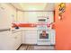 Bright kitchen with white cabinets, and modern appliances at 726 Erie Ct, Lakeland, FL 33803