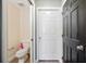 Small bathroom with toilet and adjacent door at 8309 Porch Ct, Lakeland, FL 33810