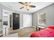 Bedroom with red bedding, ceiling fan and closet at 8309 Porch Ct, Lakeland, FL 33810