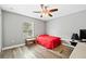 Bedroom with red bedding, desk and ceiling fan at 8309 Porch Ct, Lakeland, FL 33810