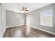 Simple bedroom with wood-look floors and ceiling fan at 8309 Porch Ct, Lakeland, FL 33810