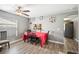 Dining area with a red tablecloth and pass-through to kitchen at 8309 Porch Ct, Lakeland, FL 33810