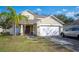 House exterior featuring a two-car garage and front yard at 8309 Porch Ct, Lakeland, FL 33810