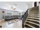 Living area showcasing a sectional sofa and staircase at 8309 Porch Ct, Lakeland, FL 33810
