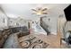 Spacious living room with grey sectional sofa and hardwood floors at 8309 Porch Ct, Lakeland, FL 33810