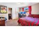 Bright bedroom with striped bedding and a workspace at 1133 N Brunnell Pkwy, Lakeland, FL 33805