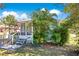 Light green house with a screened porch and tropical plants at 1133 N Brunnell Pkwy, Lakeland, FL 33805