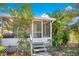 Charming home featuring an enclosed sunroom and tropical landscaping, perfect for relaxing outdoors at 1133 N Brunnell Pkwy, Lakeland, FL 33805