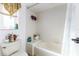 Bathroom featuring a tiled shower/tub and a neutral-colored toilet and countertop at 1452 Grand Cayman Cir, Winter Haven, FL 33884