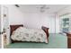 Bedroom featuring a wood frame bed, closet, green carpet and a ceiling fan at 1452 Grand Cayman Cir, Winter Haven, FL 33884