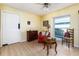 Comfortable bedroom featuring hardwood floors, a dresser, and a large window letting in natural light at 1452 Grand Cayman Cir, Winter Haven, FL 33884