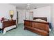 Bedroom featuring a wood frame bed, dresser, green carpet and a ceiling fan at 1452 Grand Cayman Cir, Winter Haven, FL 33884