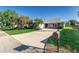 Lovely single-story home featuring well-manicured landscaping, a curved driveway and an attached two-car garage at 1452 Grand Cayman Cir, Winter Haven, FL 33884