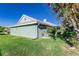 Side of the home featuring a green lawn and plenty of green bushes at 1452 Grand Cayman Cir, Winter Haven, FL 33884