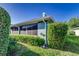 Side view of home with bushes and green lawn at 1452 Grand Cayman Cir, Winter Haven, FL 33884