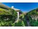 Back exterior view of home, surrounded by lush bushes and landscaping at 1452 Grand Cayman Cir, Winter Haven, FL 33884