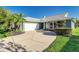 Charming single story home with mature landscaping, curved driveway, and attached two-car garage at 1452 Grand Cayman Cir, Winter Haven, FL 33884