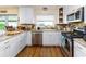 Kitchen featuring stainless steel appliances, tiled backsplash, granite countertops and white cabinetry at 1452 Grand Cayman Cir, Winter Haven, FL 33884