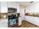 Kitchen featuring stainless steel appliances, tiled backsplash, granite countertops and white cabinetry at 1452 Grand Cayman Cir, Winter Haven, FL 33884