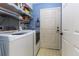 Bright laundry room featuring a washer, dryer, utility sink, and plenty of storage space at 1452 Grand Cayman Cir, Winter Haven, FL 33884