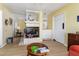 Bright living room featuring hardwood floors, a fireplace, and convenient access to a small wet bar at 1452 Grand Cayman Cir, Winter Haven, FL 33884