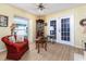 Sitting area with hardwood flooring, a corner cabinet, and glass paneled doors leading to the lanai at 1452 Grand Cayman Cir, Winter Haven, FL 33884