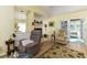 Cozy living room space offering hardwood floors, comfortable seating, and sliding glass doors to the lanai at 1452 Grand Cayman Cir, Winter Haven, FL 33884