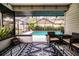 Covered patio with pool view and stylish patterned rug at 1535 New Jersey Oaks Ct, Lakeland, FL 33801