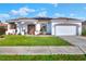 House exterior featuring a brown door, white walls, and a landscaped front yard at 1561 Shorewood Dr, Auburndale, FL 33823