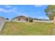 Large backyard with grassy lawn and home view at 1570 Doves View Cir, Auburndale, FL 33823