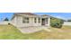 Home's back with patio and landscaped yard at 1570 Doves View Cir, Auburndale, FL 33823