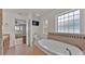 Bathroom with garden tub, tile floors and bedroom access at 1570 Doves View Cir, Auburndale, FL 33823