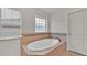 Oval soaking tub with tile surround in this bathroom at 1570 Doves View Cir, Auburndale, FL 33823