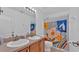 Bathroom with double sinks and patterned shower curtain at 1570 Doves View Cir, Auburndale, FL 33823