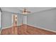 Well-lit bedroom with wood floors and access to bathroom at 1570 Doves View Cir, Auburndale, FL 33823