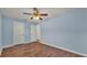 Light blue bedroom with wood floors and ceiling fan at 1570 Doves View Cir, Auburndale, FL 33823